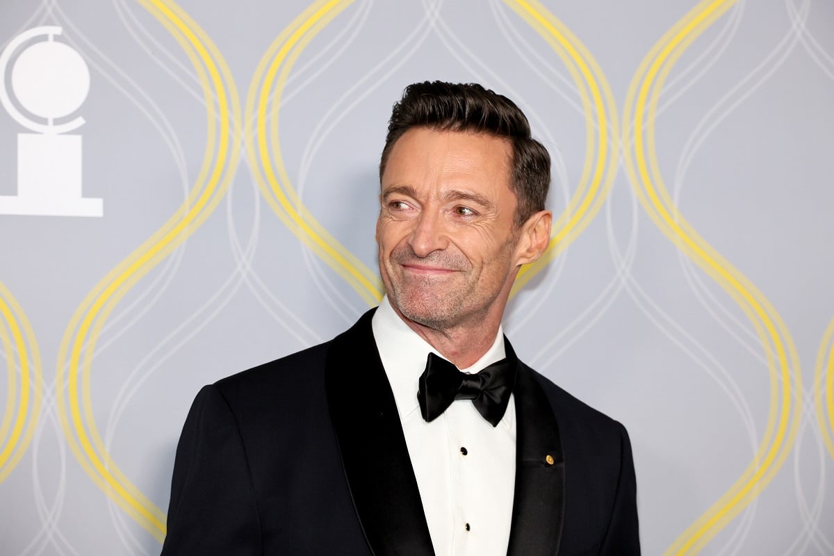 Hugh Jackman smiling while wearing a suit.