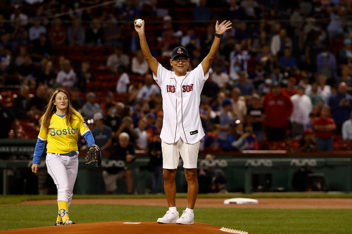 Japanese Iron Chef Masaharu Morimoto waves to fans before throwing out the ceremonial opening pitch for the Boston Red Sox