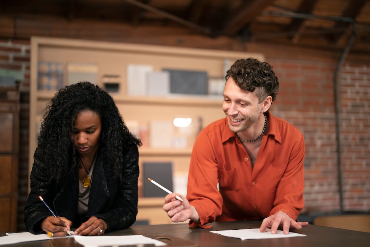 Designers Jeannette Limas and Curtis Cassell with pencils in hand in 'Making the Cut' Season 3