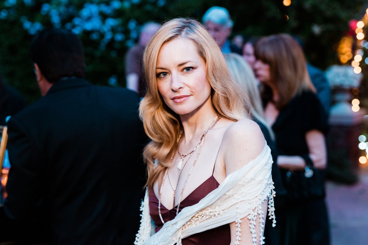 Actor Jessica Morris wearing a red dress and white wrap