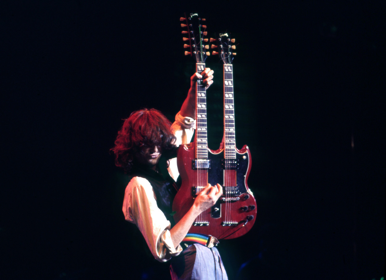 Led Zeppelin guitarist Jimmy Page performs at a 1983 benefit concert. Page once explained that playing guitar for a poet was his connection to how The Beatles got their name.