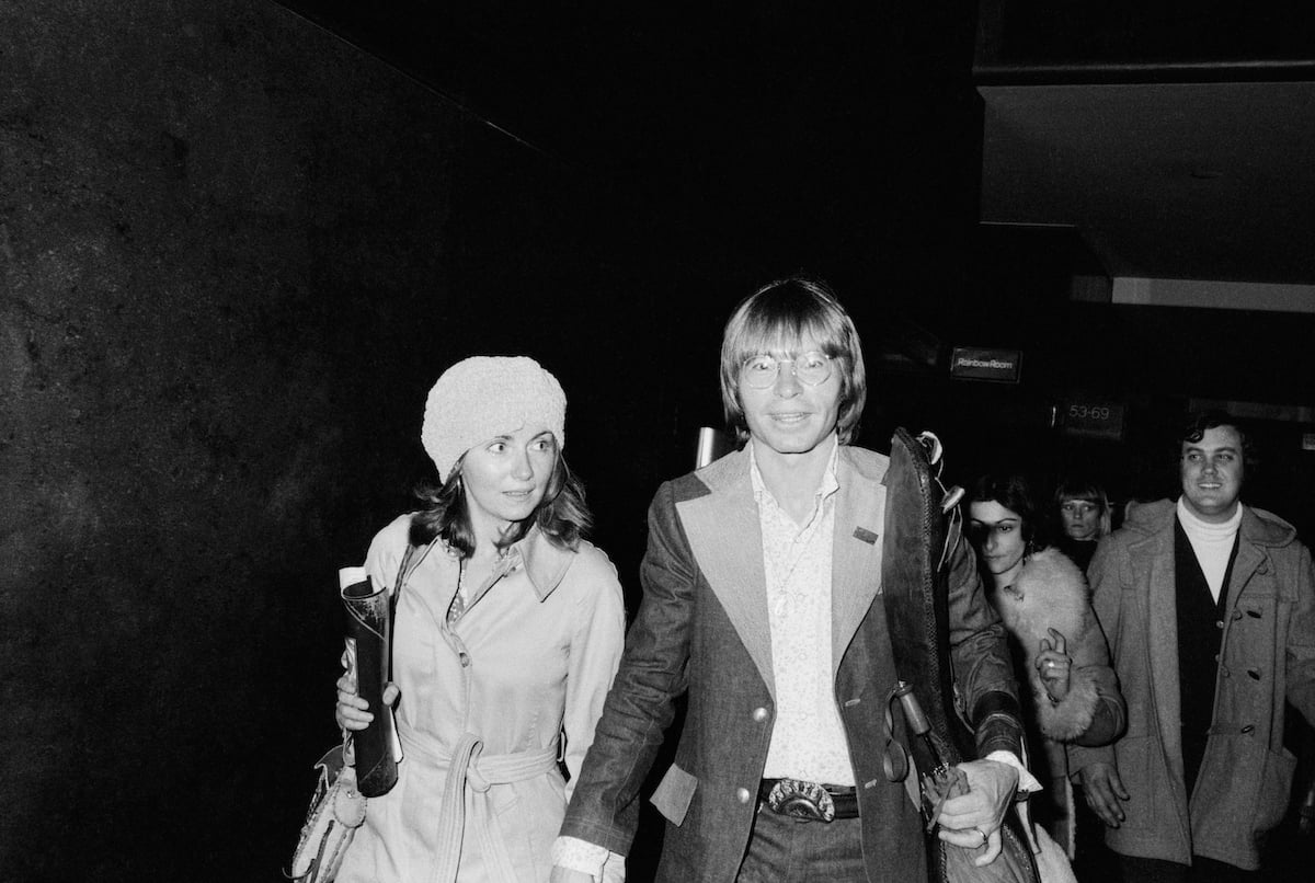 Country singer John Denver and his wife Annie walk together while holding hands in 1970
