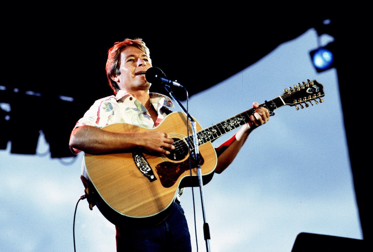 John Denver performing on stage