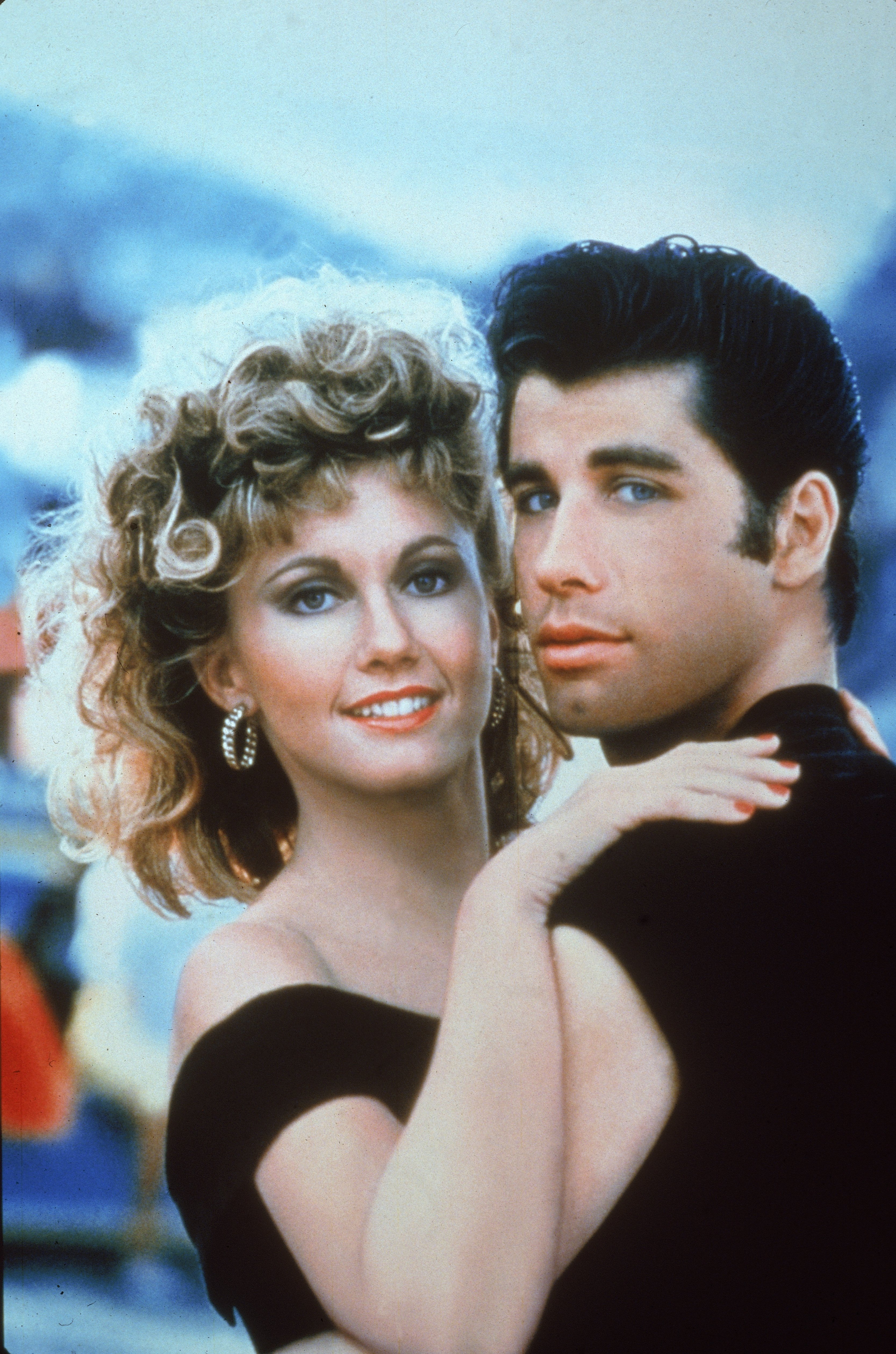 John Travolta and Olivia Newton-John, who had died, embrace in a promotional still for 'Grease'
