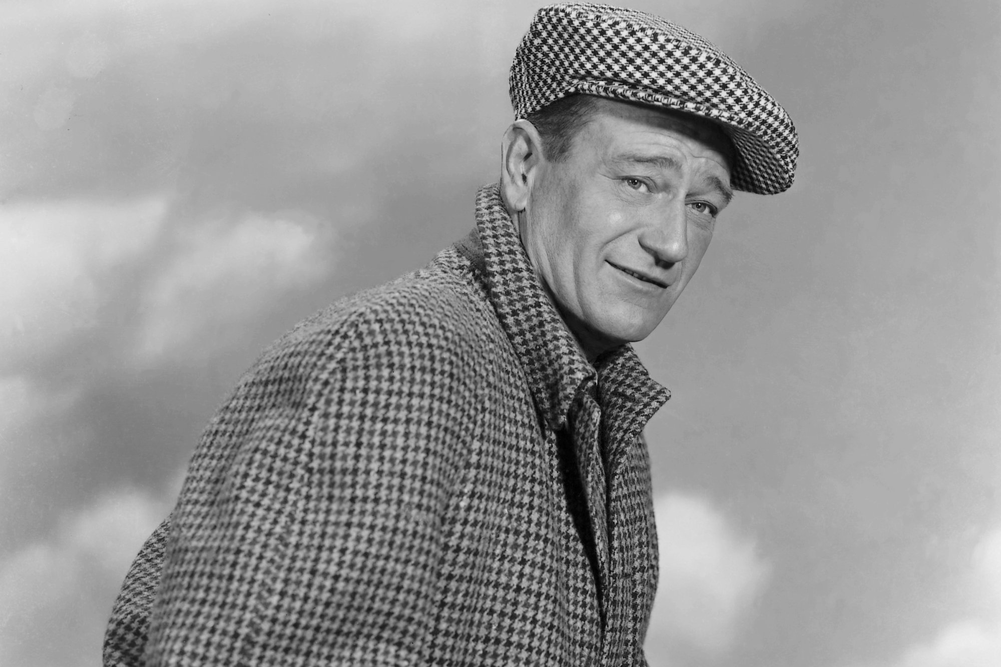 John Wayne, who had a favorite expression, wearing a checker-patterned coat and hat