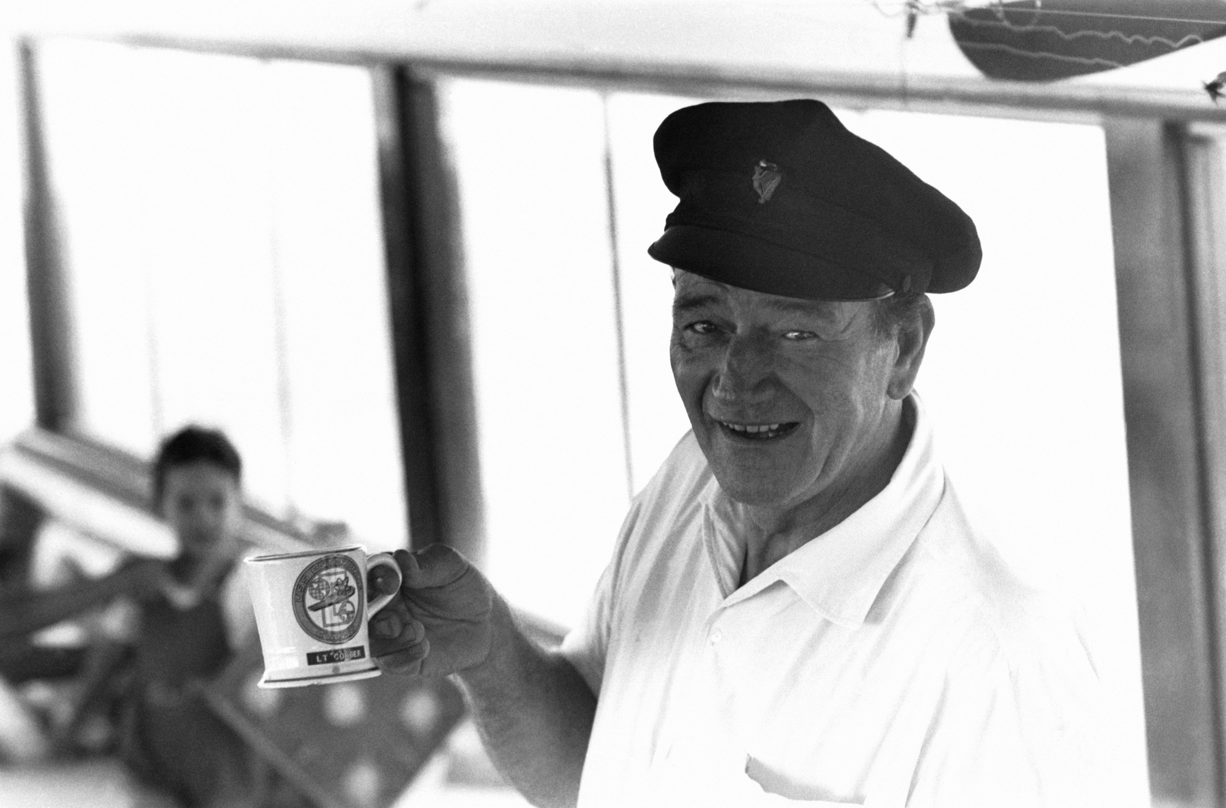 Actor John Wayne takes a portrait on a yacht