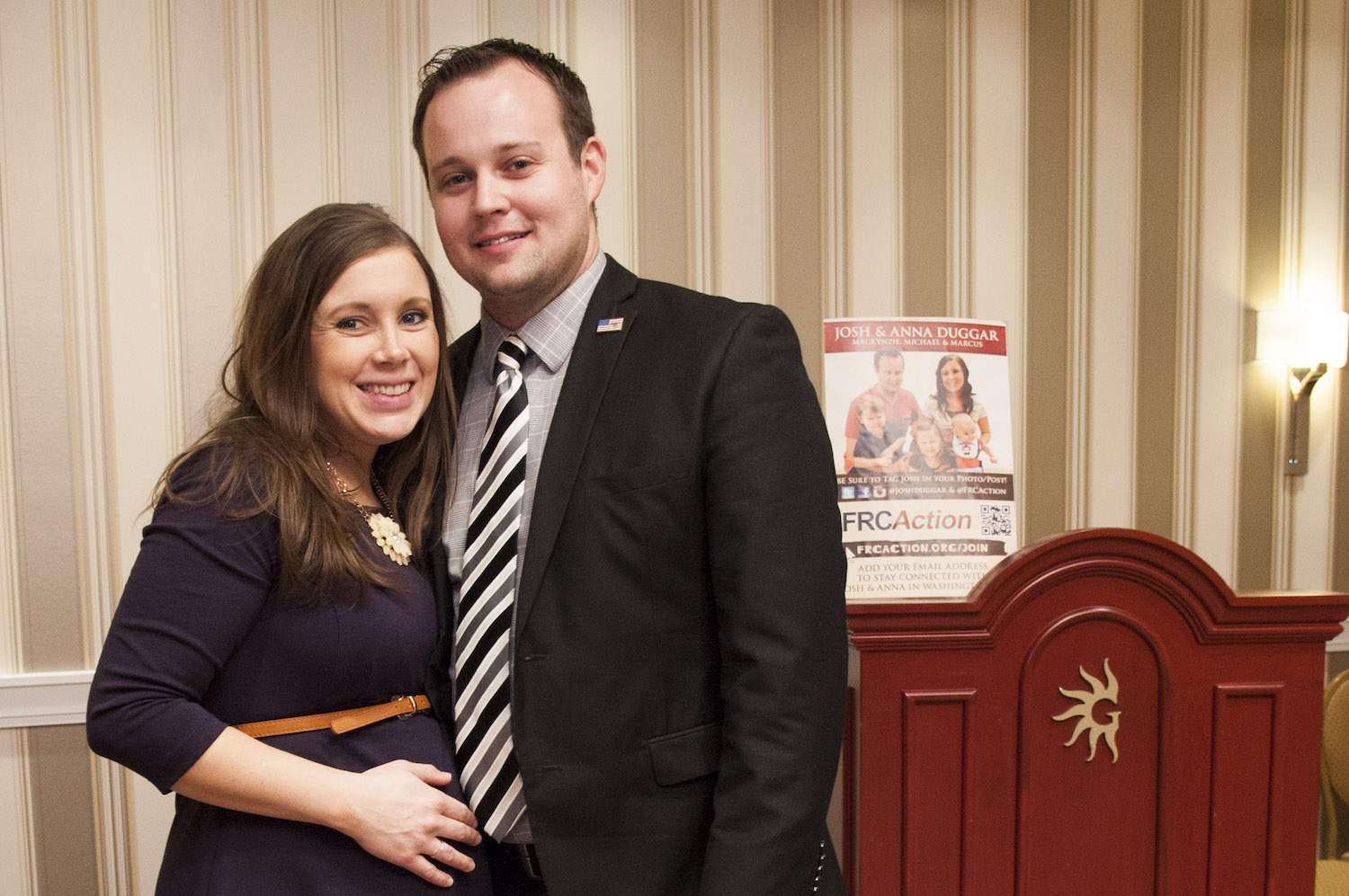 Anna Duggar and Josh Duggar of the Duggar family standing next to each other and smiling