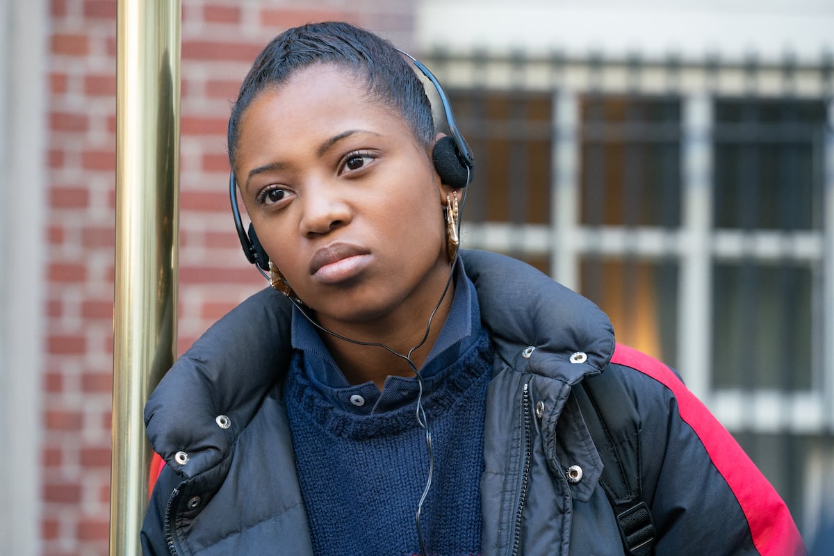 Hailey Kilgore as Jukebox wearing headphones and a puffy coat in 'Power Book III: Raising Kanan'