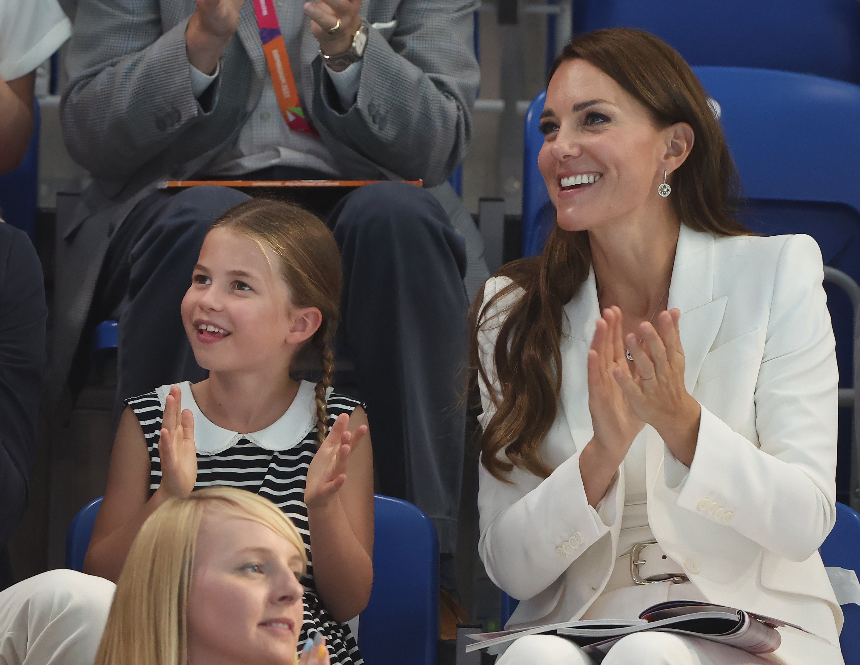 Kate Middleton and Princess Charlotte, who a body language expert says can fun just like her mom, clapping as they watch a morning swimming session at Birmingham 2022 Commonwealth Games