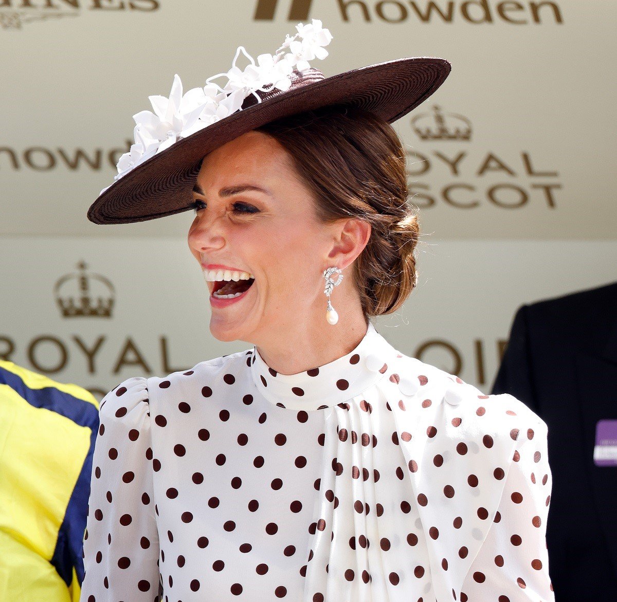 Kate Middleton laughing as she attends day 4 of Royal Ascot in a fascinator and Alessandra Rich dress