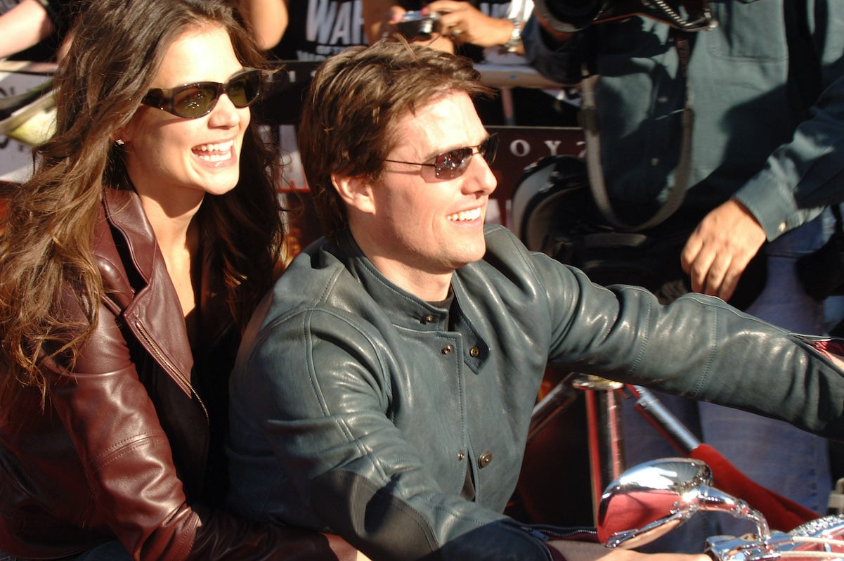 Katie Holmes and Tom Cruise, who both have a high net worth, pose on a motorcycle in 2005