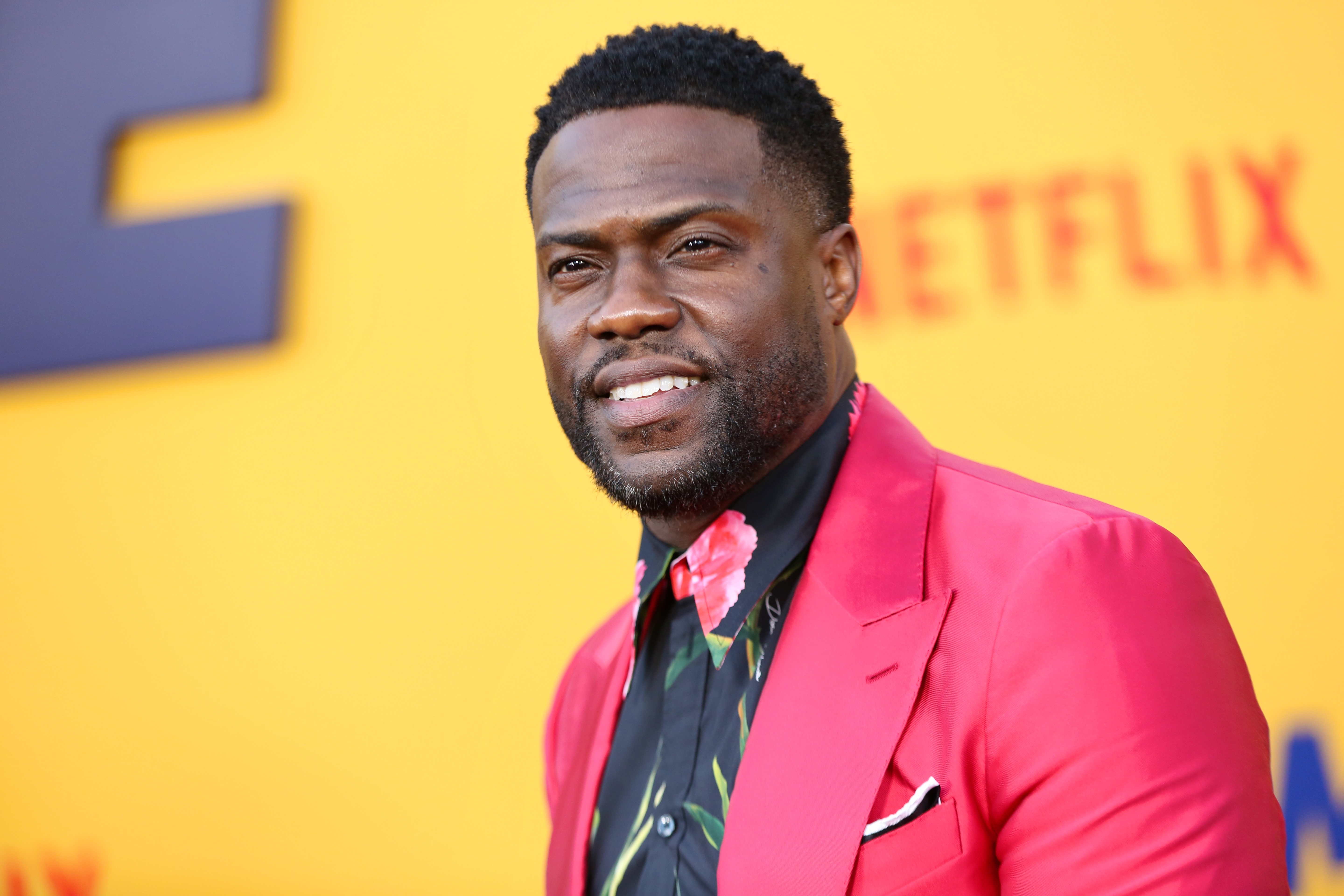 Kevin Hart wears a red jacket with floral shirt at the premiere of Netflix's 'Me Time'