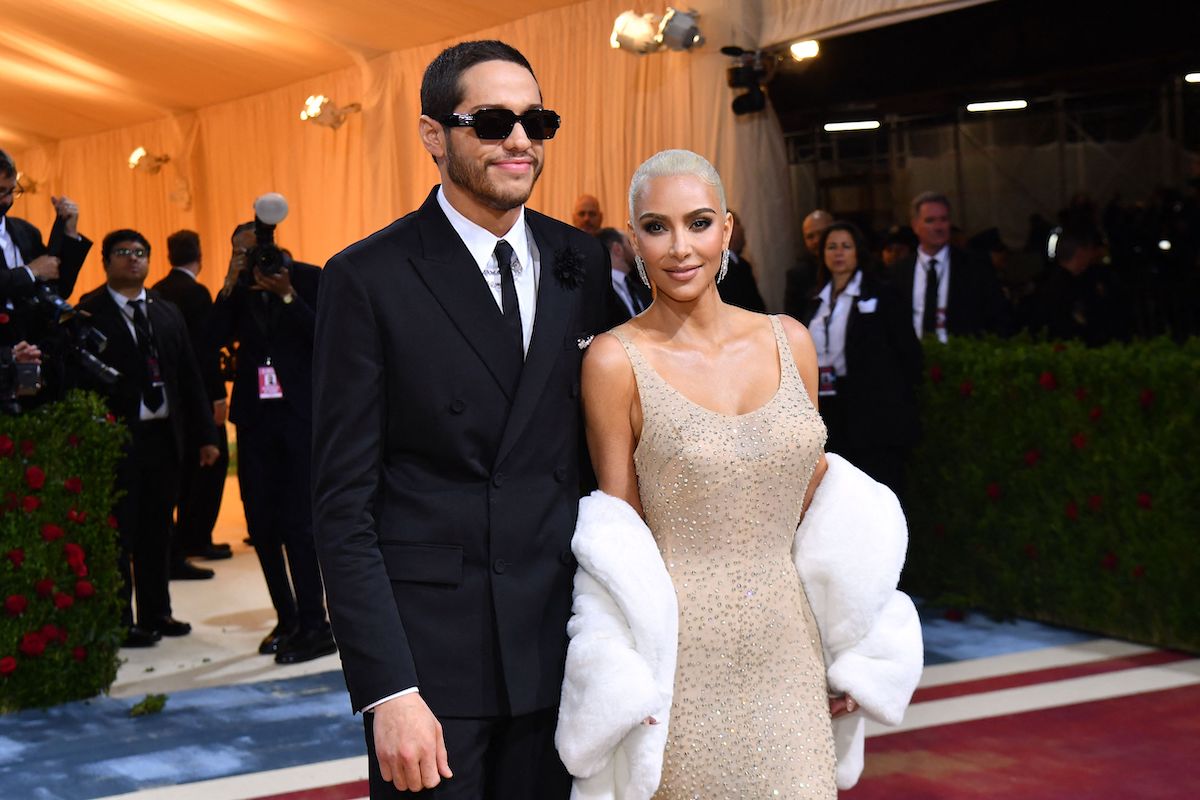 Pete Davidson and Kim Kardashian, whose body language hinted at a breakup, posing together at an event.