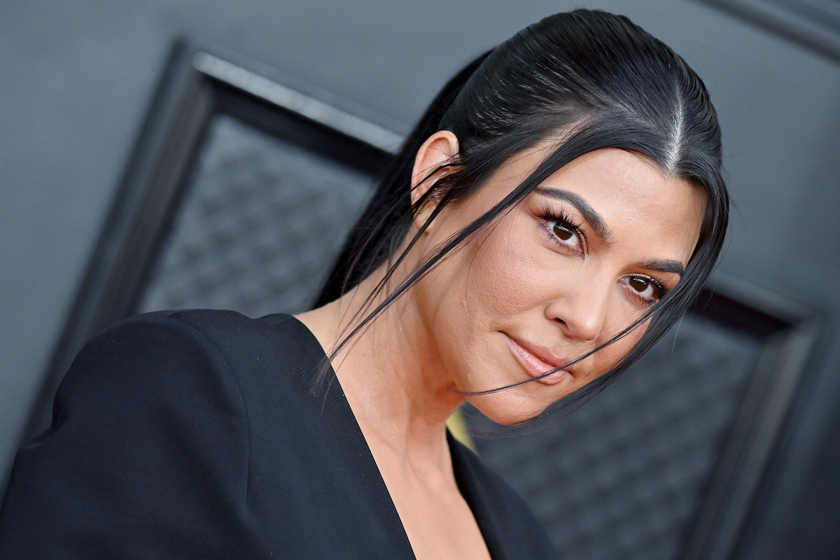 Kourtney Kardashian, who fans have labeled a hypocrite for her water usage, poses at an event.
