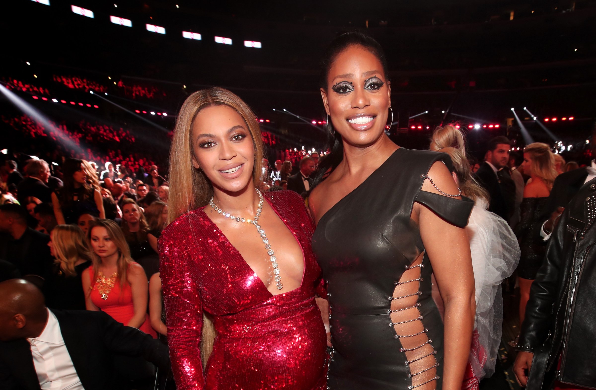 Beyoncé and Laverne Cox at the Grammy Awards. Beyoncé wearing red and Laverne wearing black.