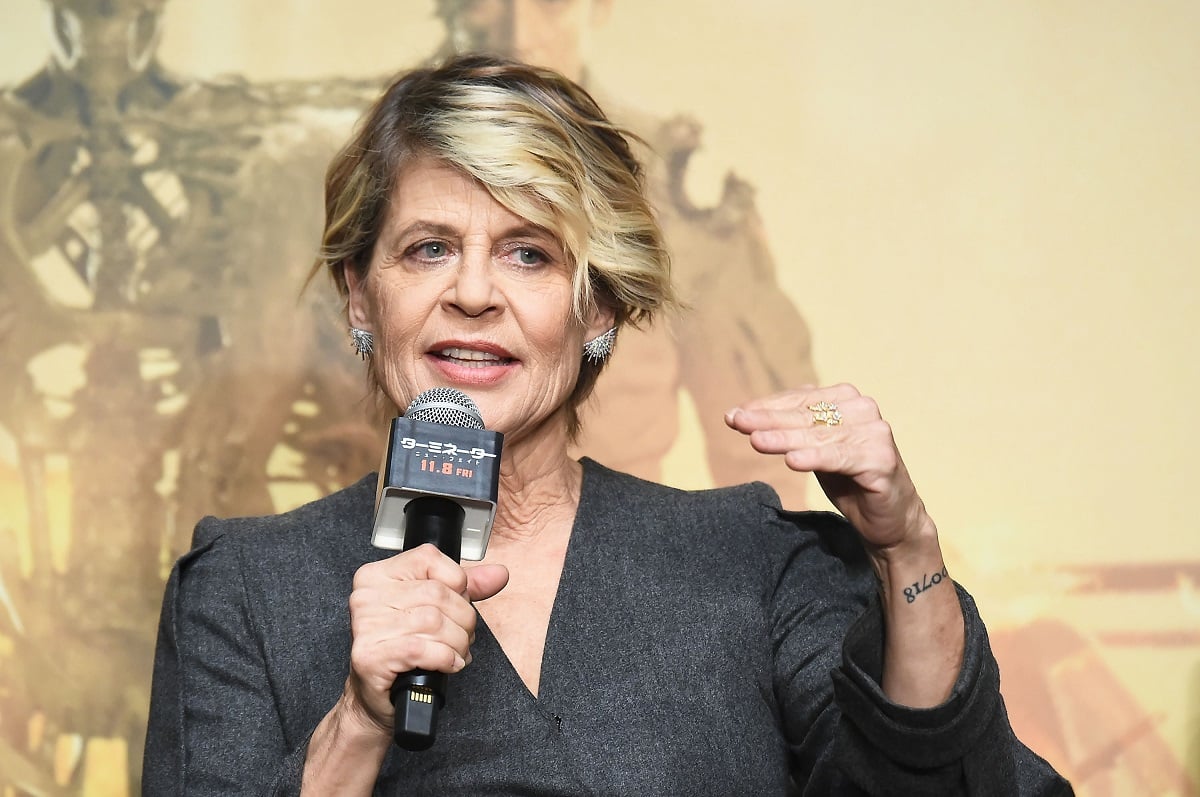 Linda Hamilton holding a microphone.