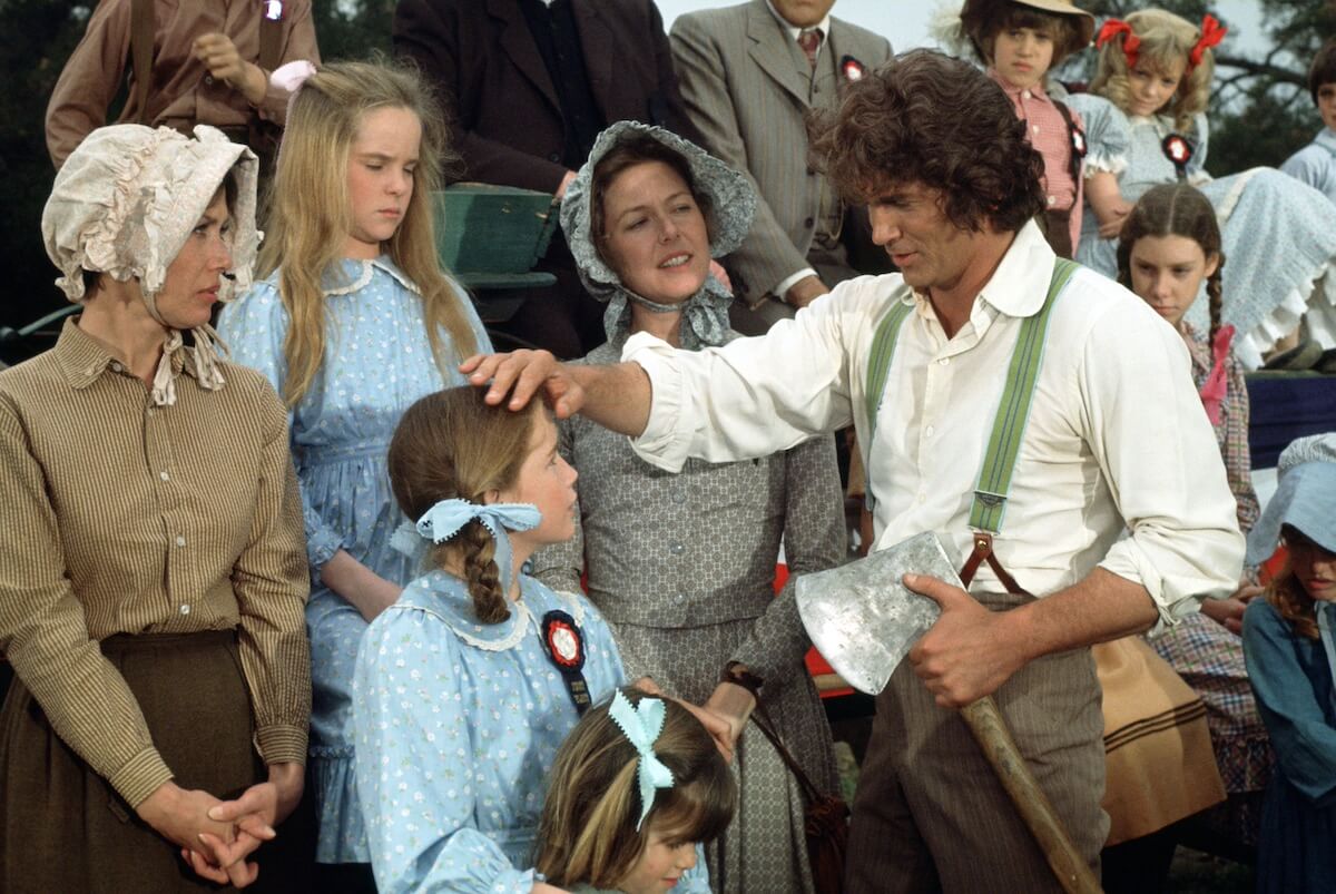 Pa (Michael Landon) with his hand on Laura's head in 'Little House on the Prairie'