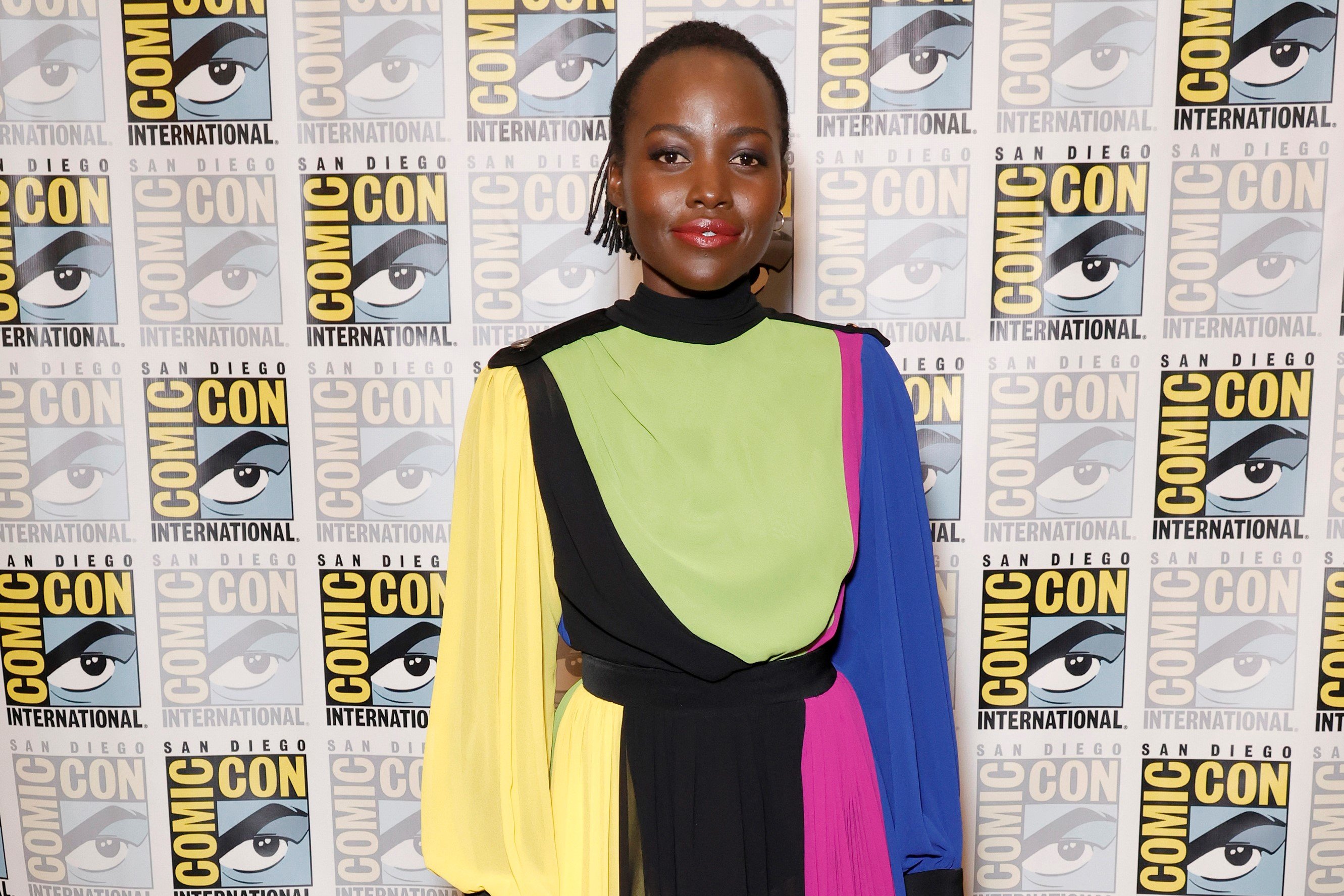 Lupita Nyong'o, who stars in 'Black Panther 2,' wears a yellow, black, green, pink, and blue dress.