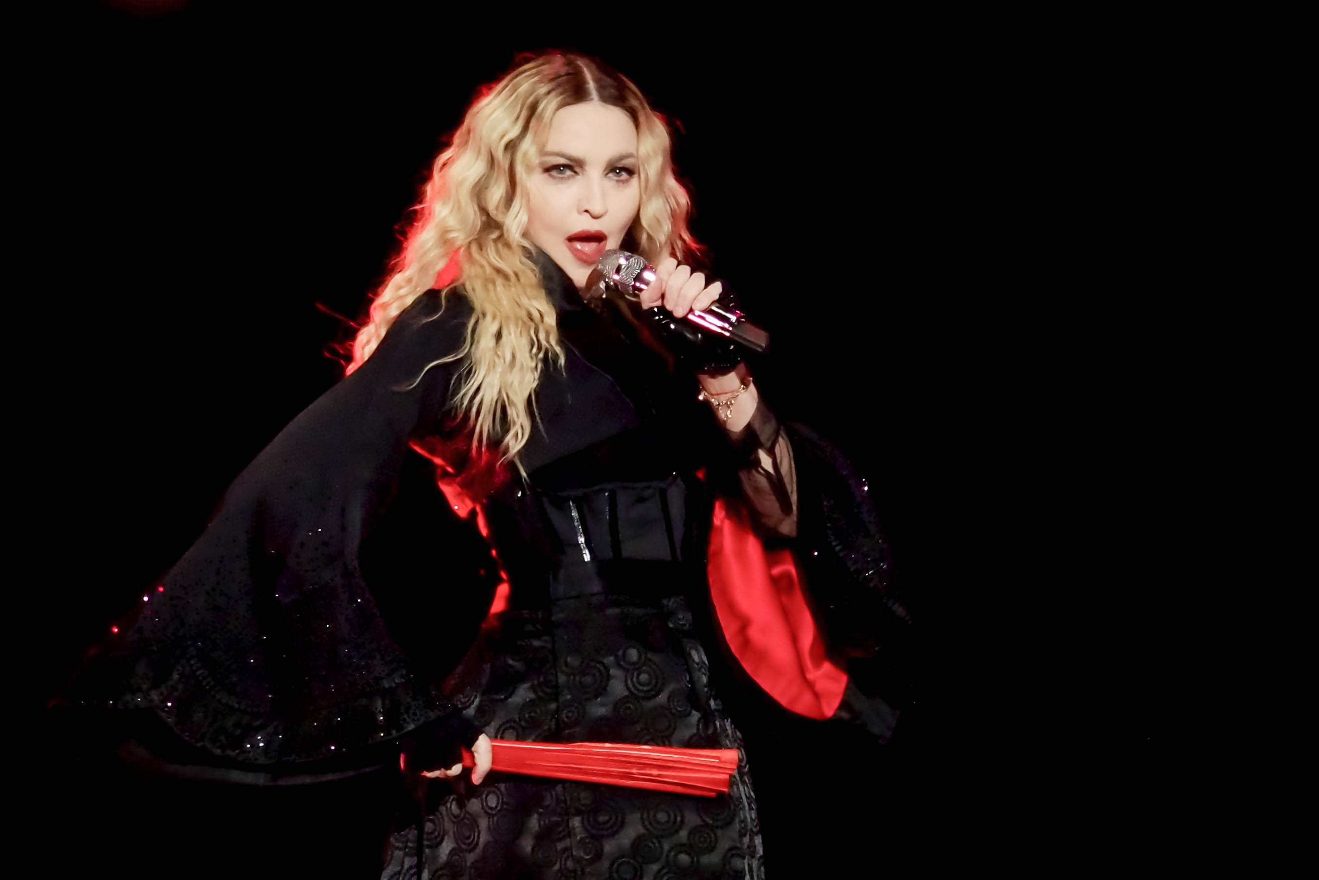 Madonna, who wants to work with Kendrick Lamar, waering black and singing