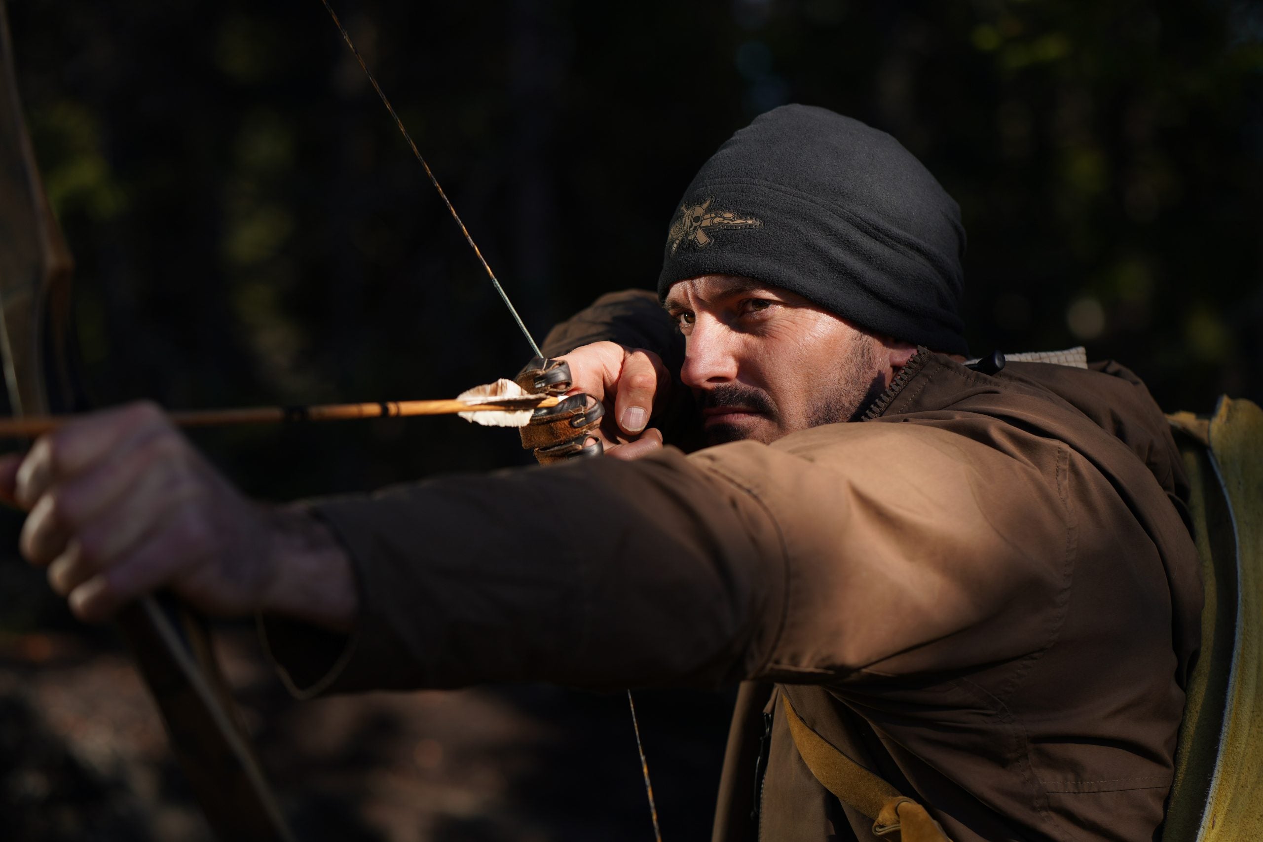 Mark, the first contestant who taps out on 'Alone: Frozen,' shooting a bow and arrow