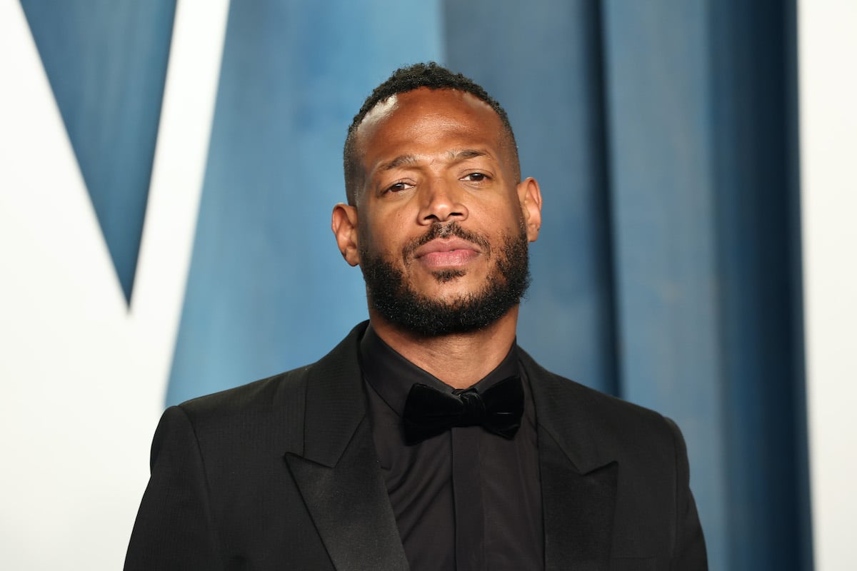 Marlon Wayans in front of a blue background
