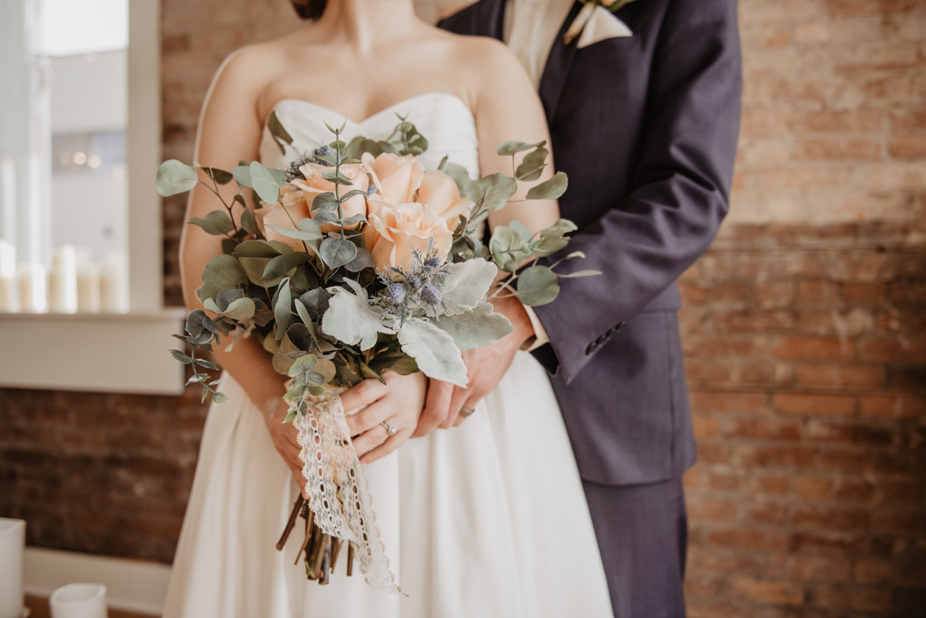 A bride holds a wedding bouquet.