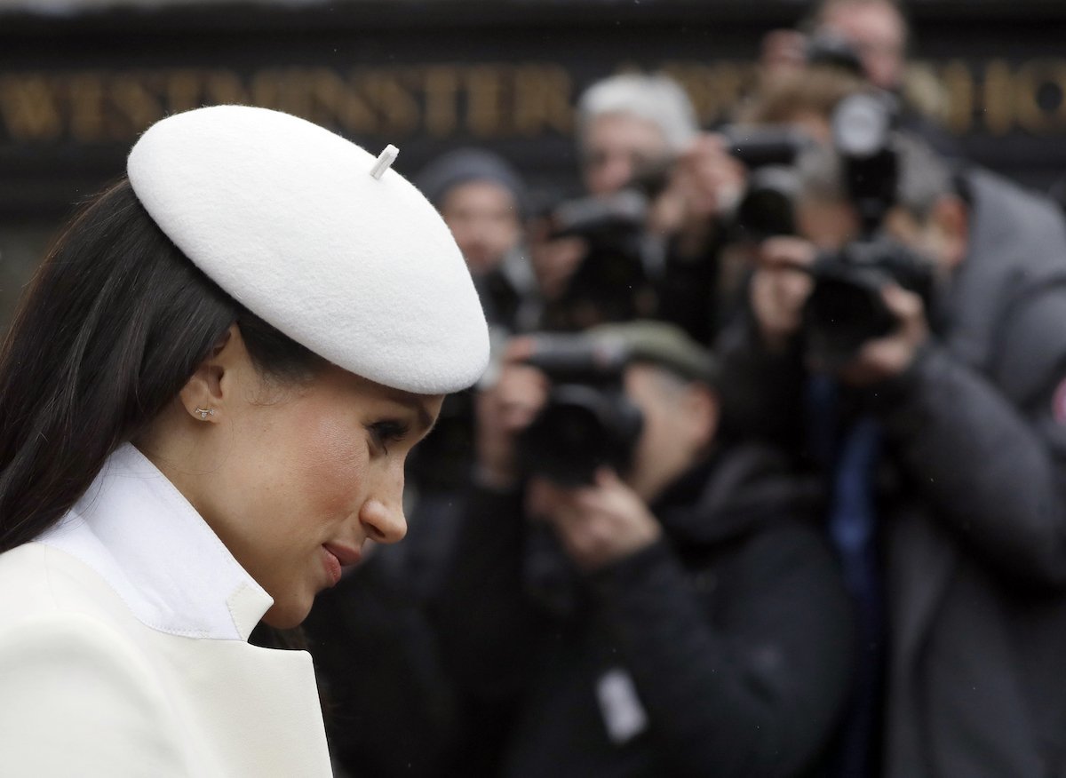 Meghan Markle, who said school drop off and pick-up would be a royal photo call in an august 2022 interview with The Cut, looks down as cameras photograph her