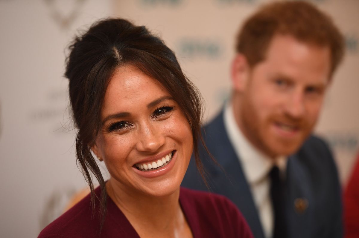 Meghan Markle, who has been compared to Princess Diana, smiles at an event.