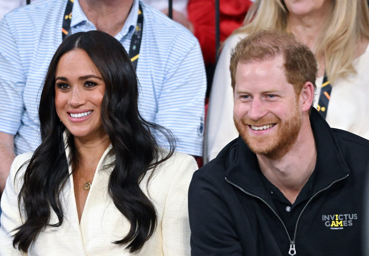Meghan Markle, who gave quotes that proved she and Prince Harry are more in love than ever in an August 2022 The Cut interview, sits with Prince Harry