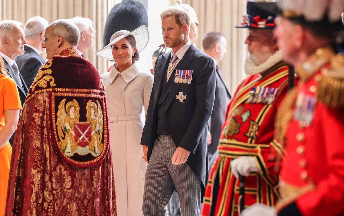 Meghan Markle and Prince Harry, whose memoir may be 'drowned out' by other books according to an expert, walk inside Westminster Abbey