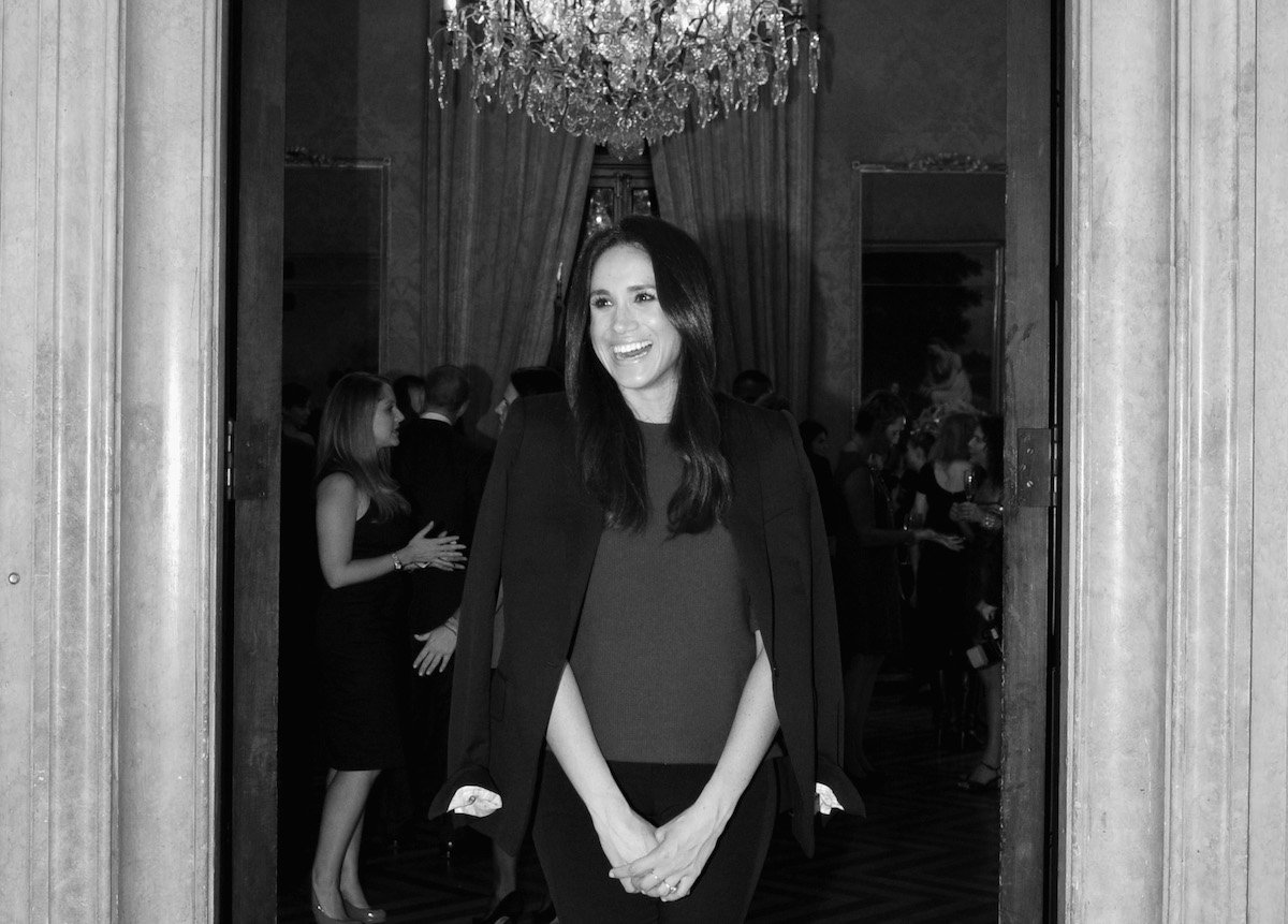 Meghan Markle, who asked for a birthday gift from The Tig readers in 2014, smiles at a 2014 dinner