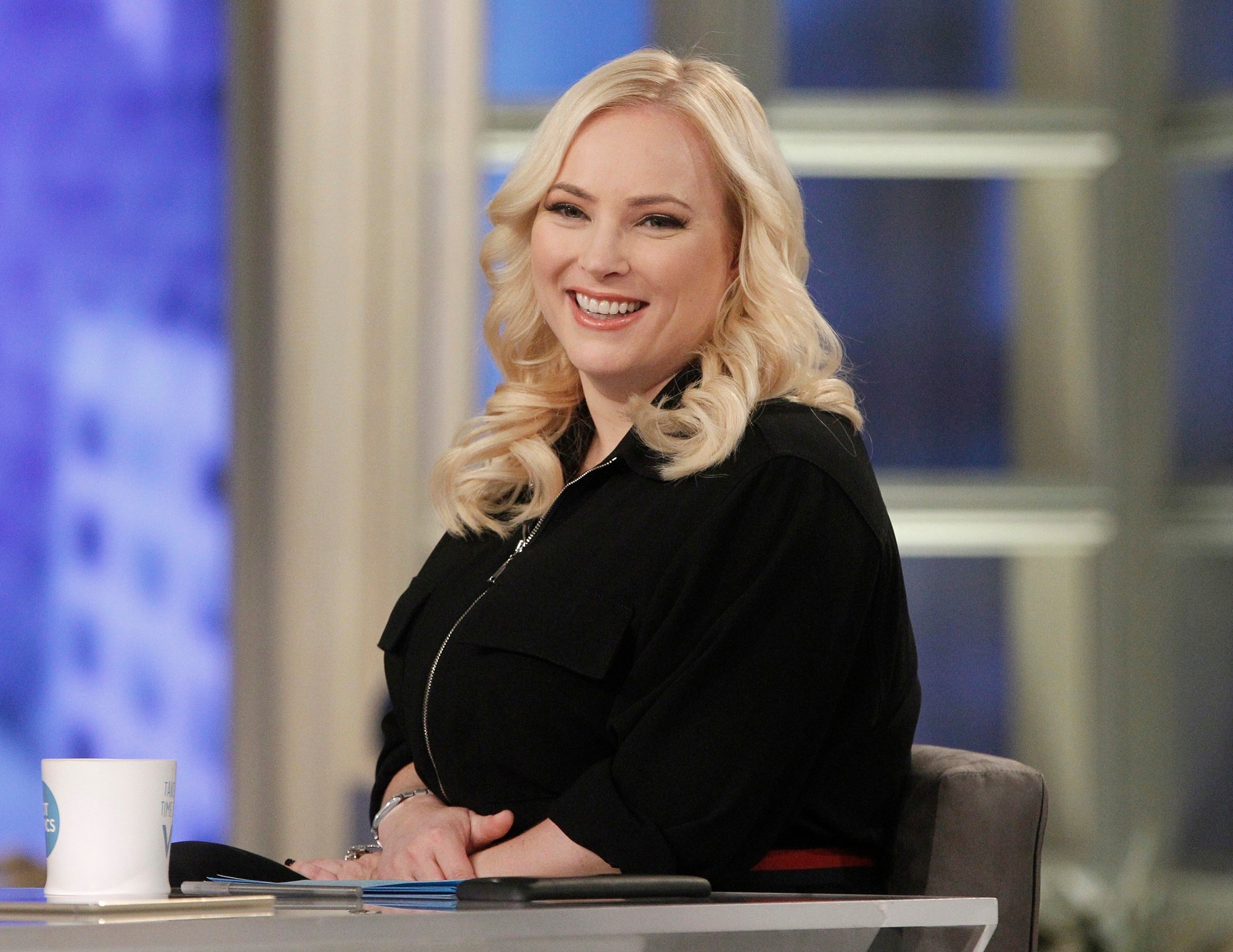 'The View' co-host Meghan McCain smiling while sitting at the Hot Topic table
