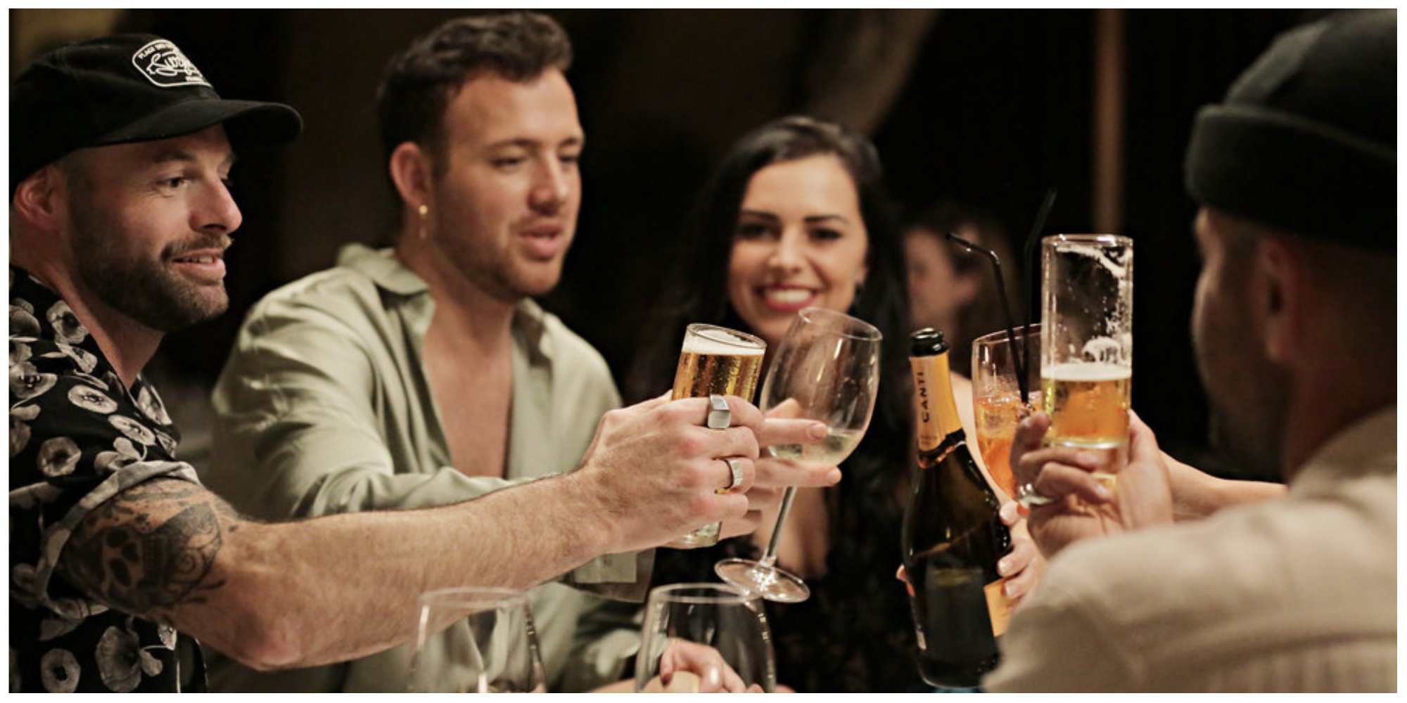 Dave White, Kyle Viljoen, Natasha Webb toast beer and champagne glasses at dinner 