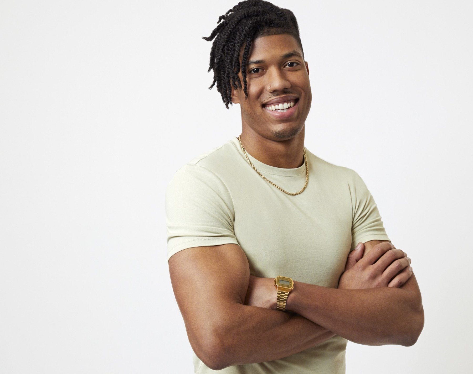'The Bachelorette' 2022 contestant Nate Mitchell. He's wearing a white T-shirt, gold chain, and crossing his arms.