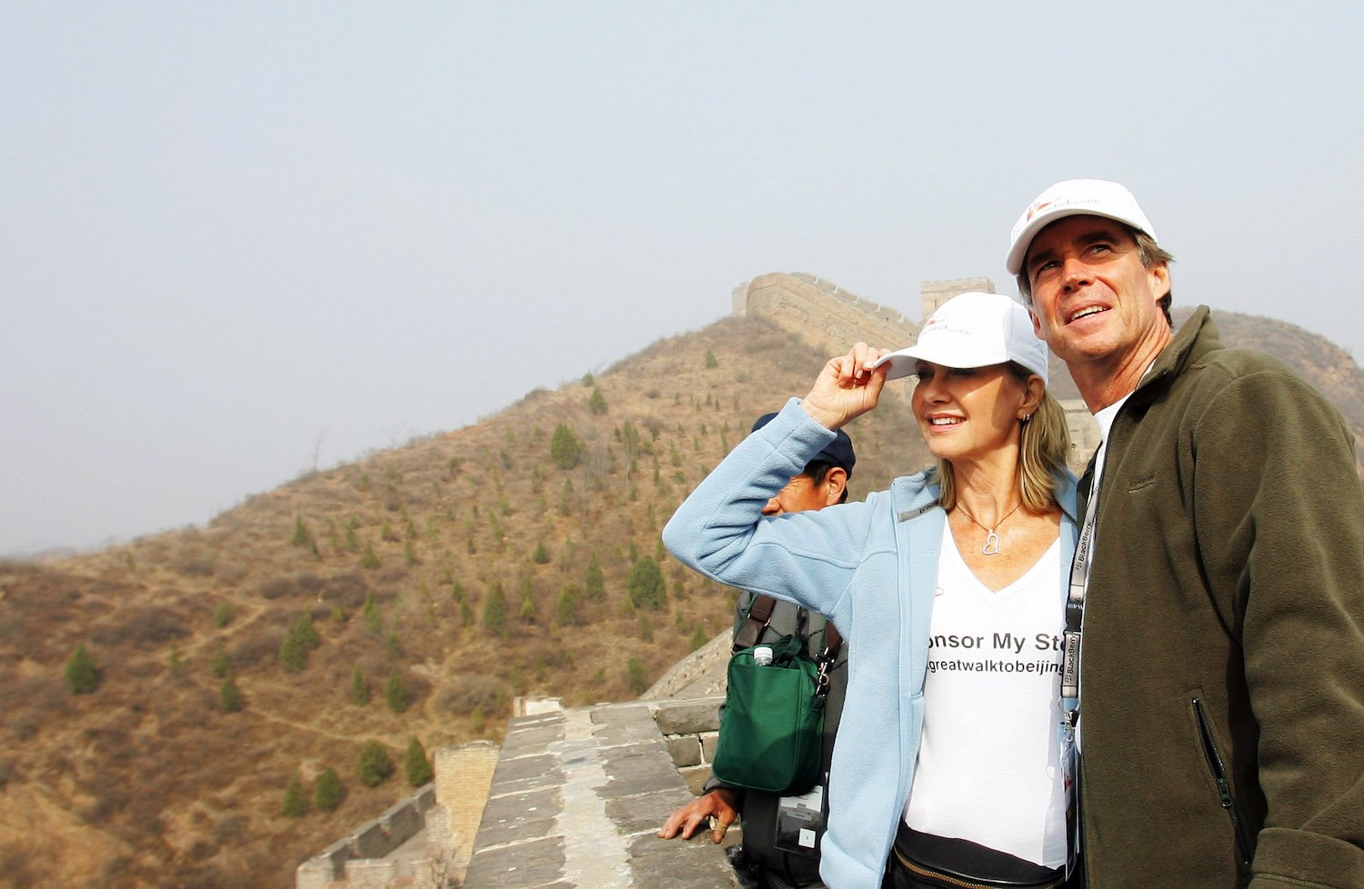 Olivia Newton-John standing next to her husband, John Easterling, outside for The Great Walk of China
