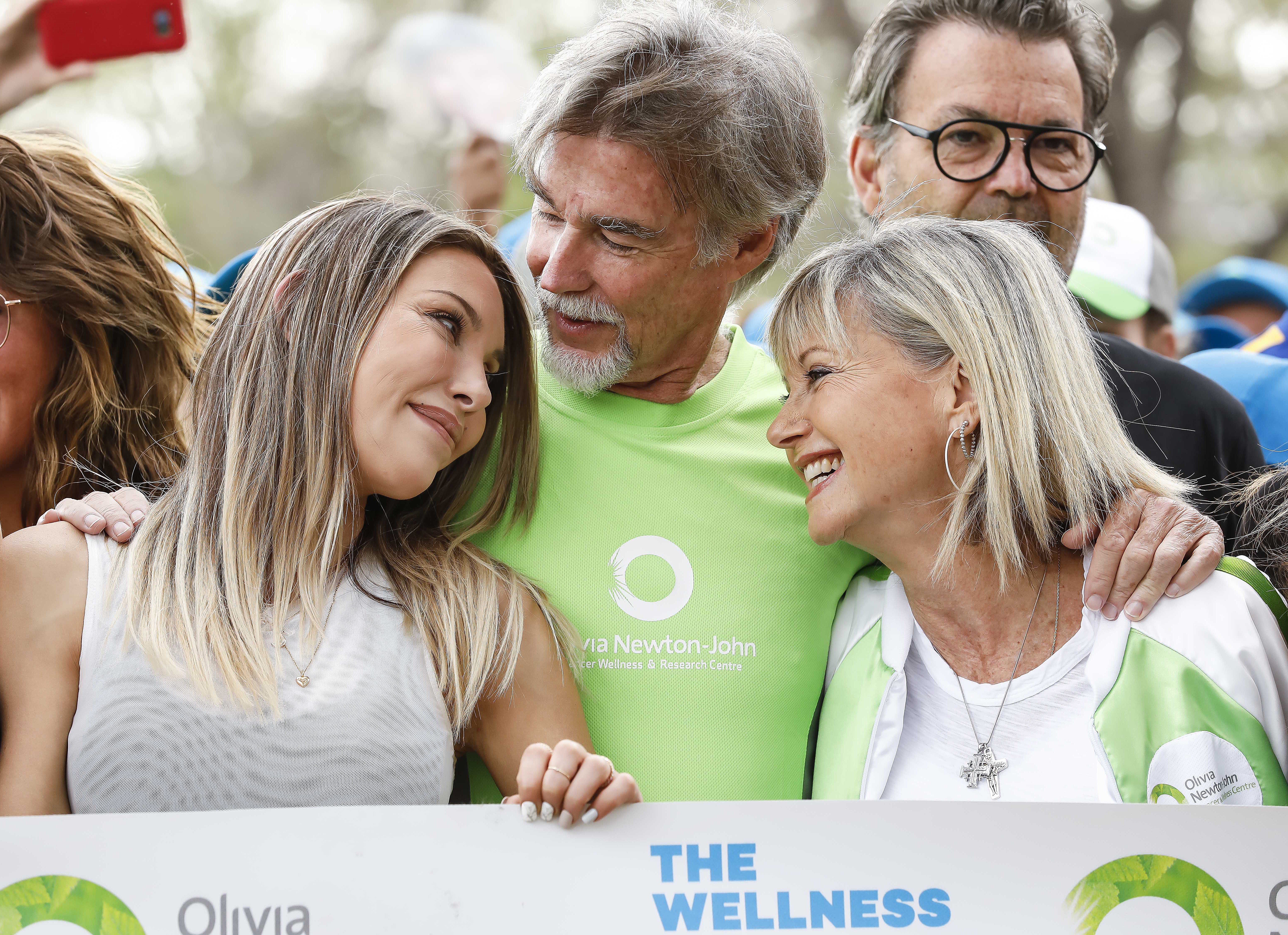 Olivia Newton-John's daughter, Chloe Lattanzi, and husband, John Easterling, smiling at the star's Wellness Walk and Research Run