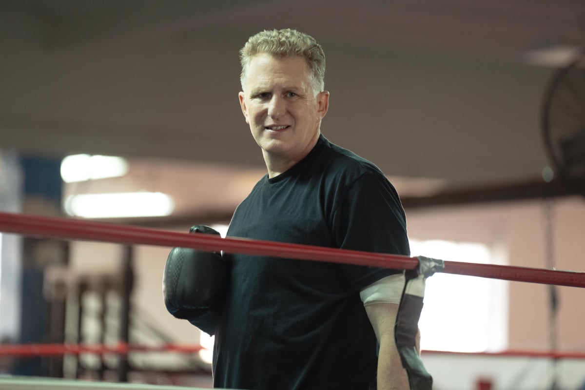 Michael Rapaport as Detective Kreps in Only Murders in the Building Season 2. Kreps stands in a boxing ring wearing boxing gloves. 