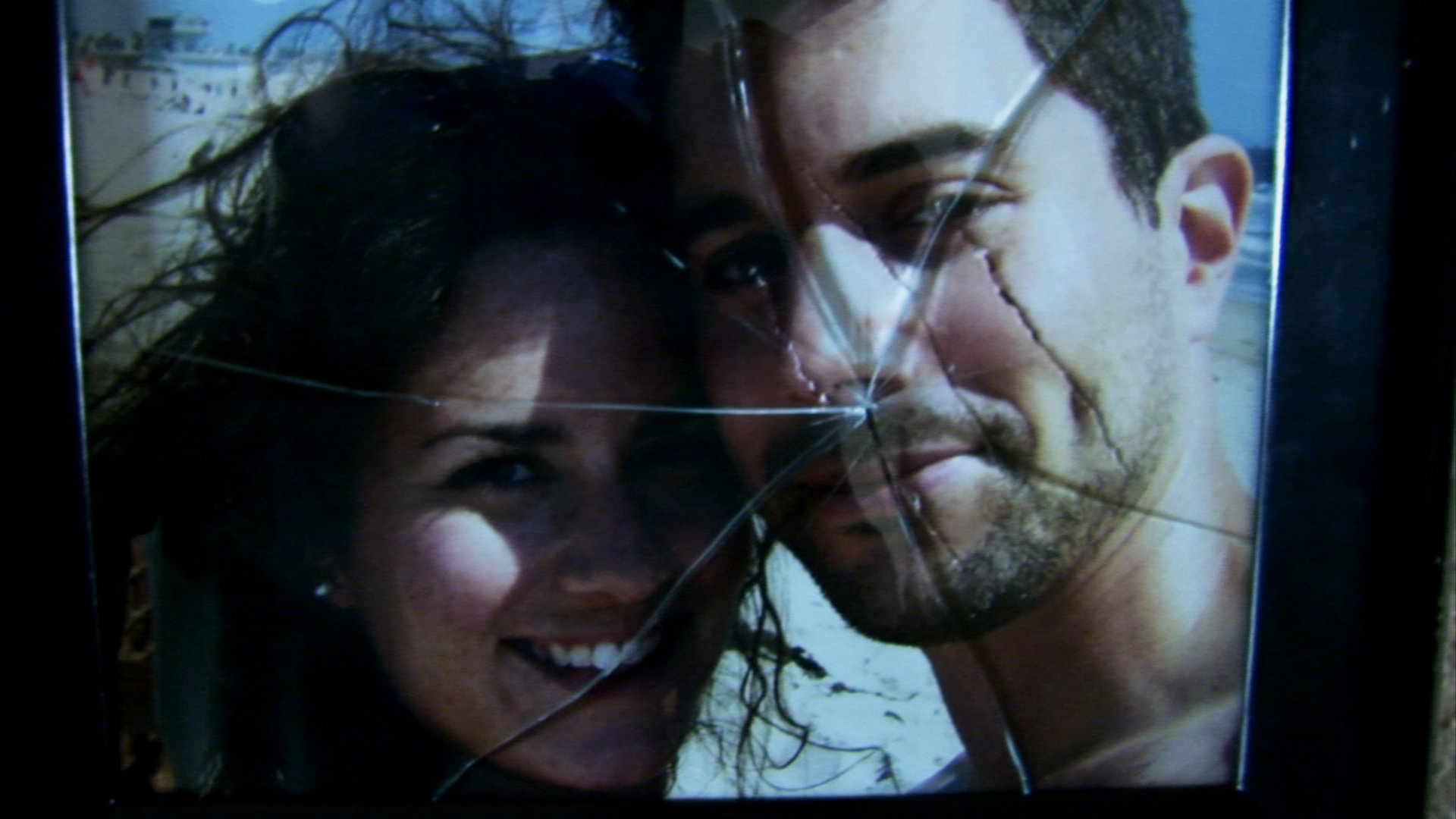 'Paranormal Activity' Katie Featherston and Micah Sloat, who inspired the sequels. A picture of them smiling with the glass shattered and a scratch over Micah's face in the picture.