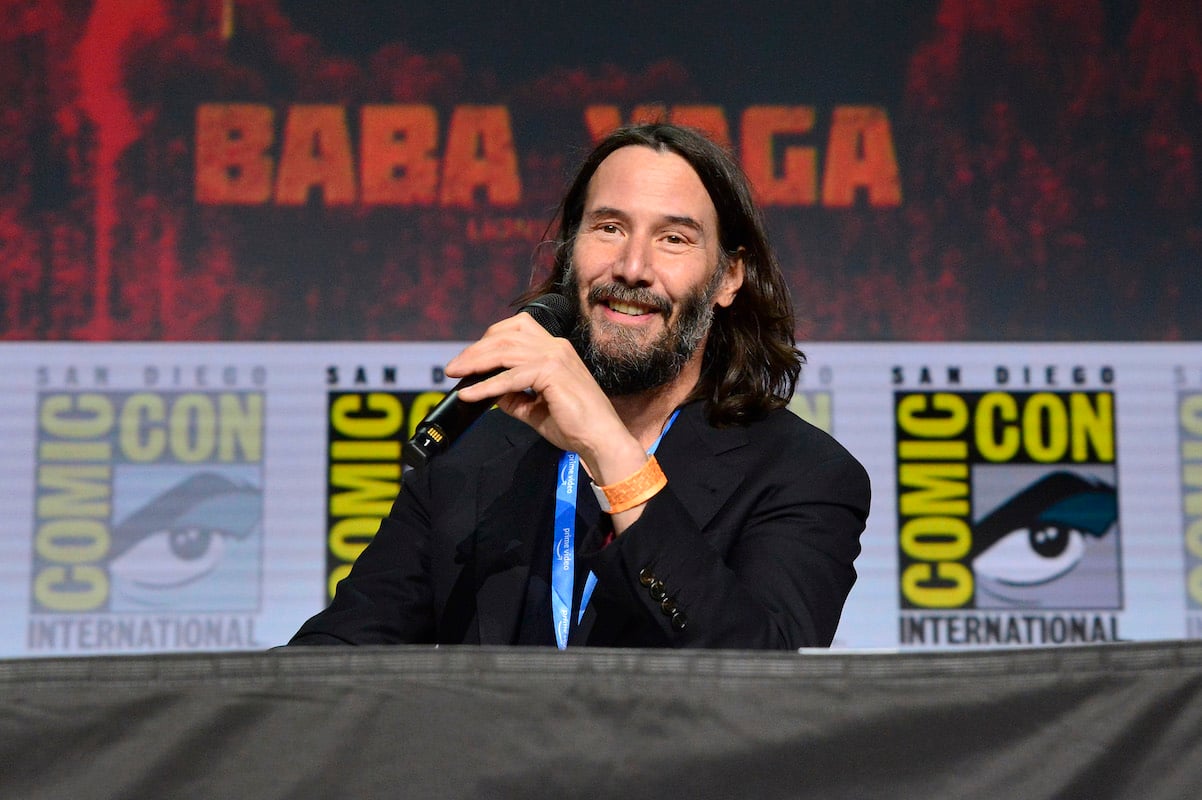 'Point Break' star Keanu Reeves holds a microphone at Comic-Con 2022