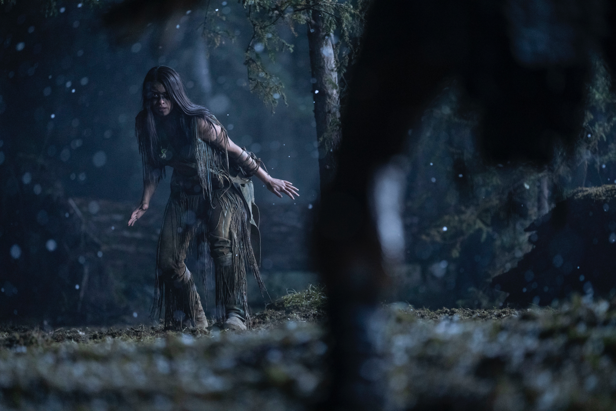 'Prey' Amber Midthunder as Naru and Dane DiLiegro as Predator. Naru is holding her hands out toward the ground and the Predator's leg is shown in the foreground.