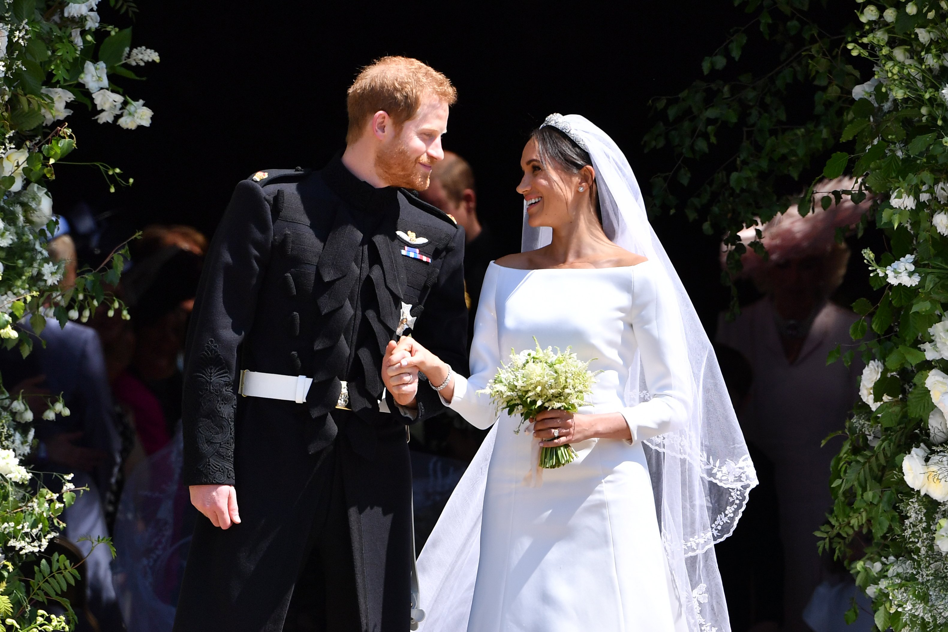 Prince Harry, who a body language expert says changed when he married Meghan Markle and made her No. 1, leave St George's Chapel following their royal wedding
