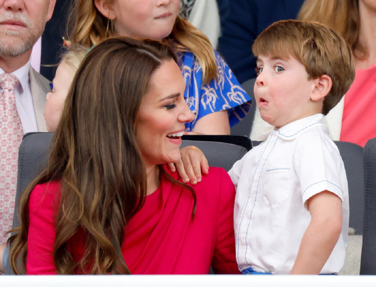 Prince Louis making a face while holding onto his mom during the Platinum Pageant
