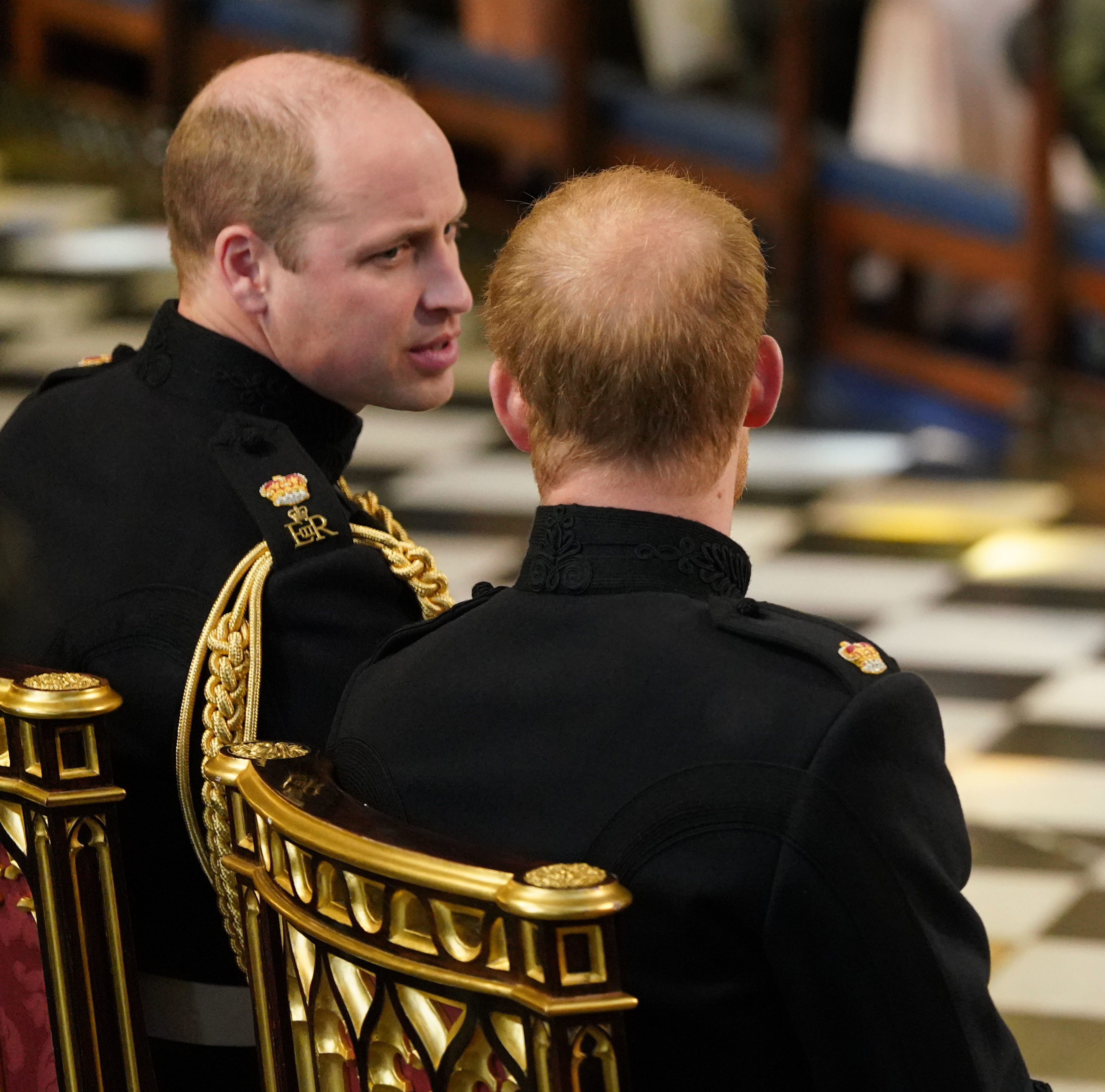 Prince William sitting next to and talking to Prince Harry ahead of the Duke of Sussex's wedding to Meghan Markle