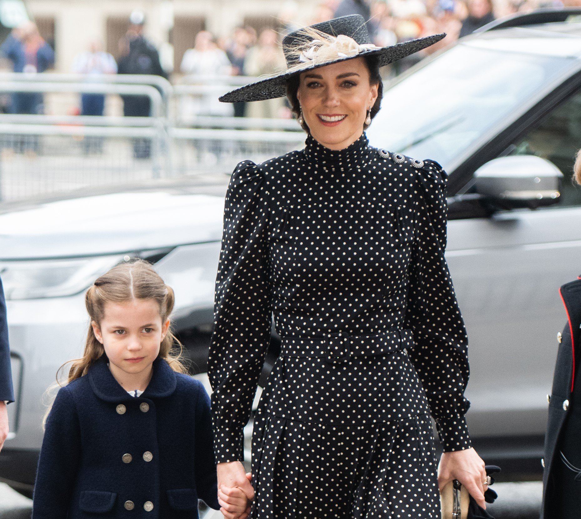 Princess Charlotte, who recently dressed just like Kate Middleton, holding her mom's hand as they arrive to Prince Philip's memorial service