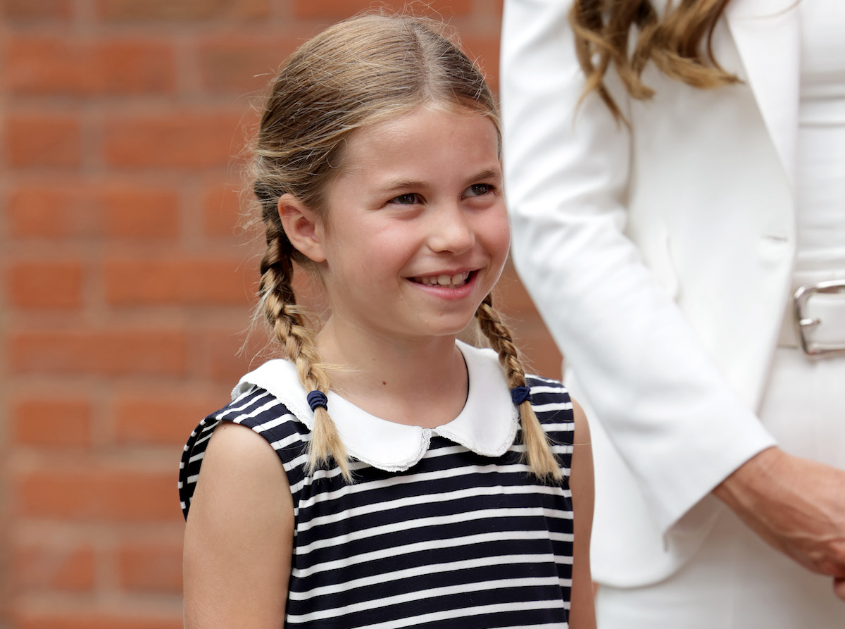 Princess Charlotte, who appeared in a video wishing the Lionesses luck alongside Prince William, smiles and looks on wearing a striped dress