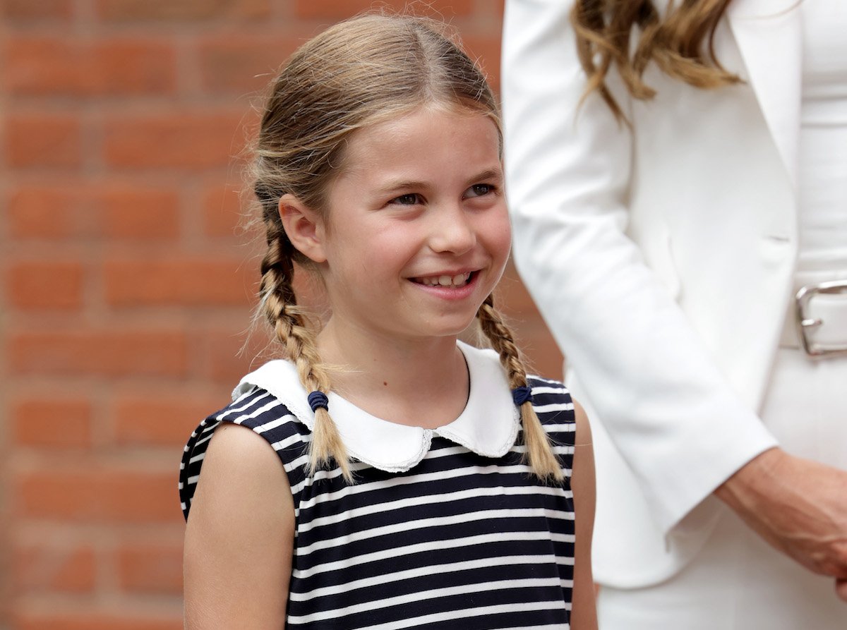 Princess Charlotte, who appeared in a video wishing the Lionesses luck alongside Prince William, smiles and looks on wearing a striped dress