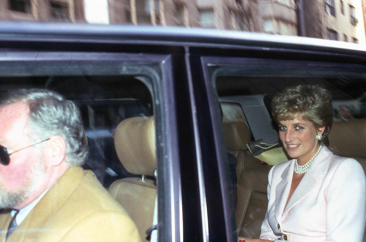 Princess Diana, whose death and the subsequent investigations are the subject of the discovery+ docuseries, 'The Princess Diana Investigations,' smiles sitting in the backseat of a car
