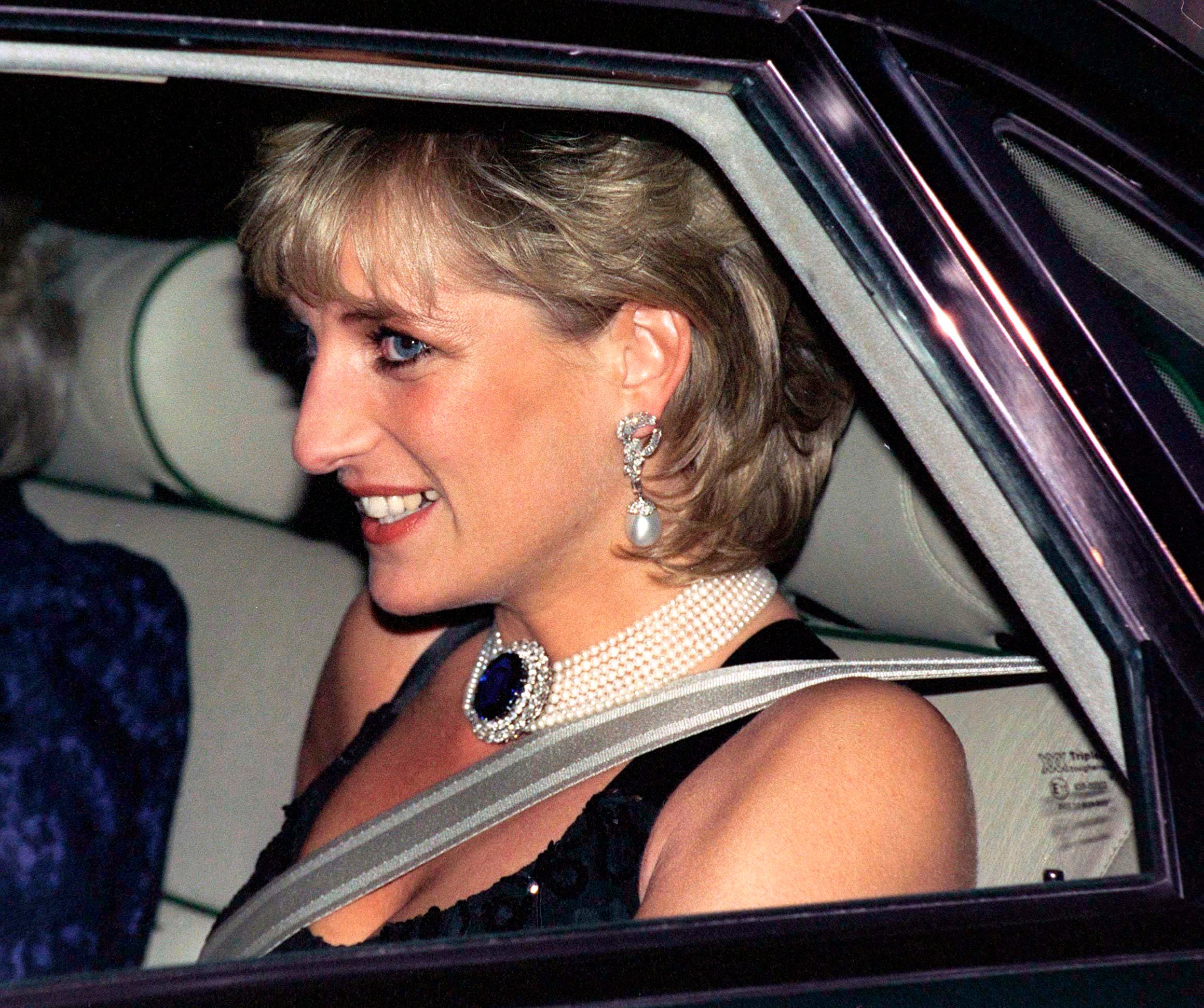 Princess Diana in the back of car with a seatbelt on