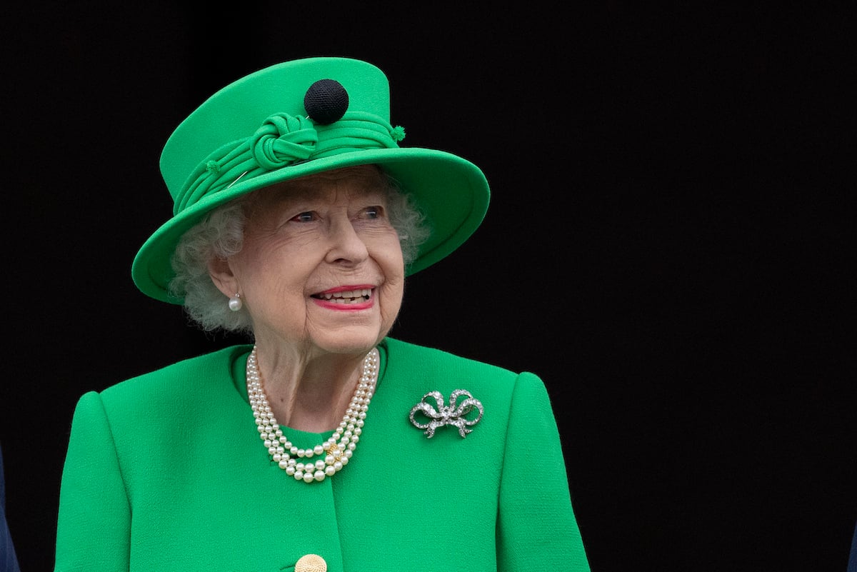 Queen Elizabeth, who flies her dogs on a private jet, smiles at an event.