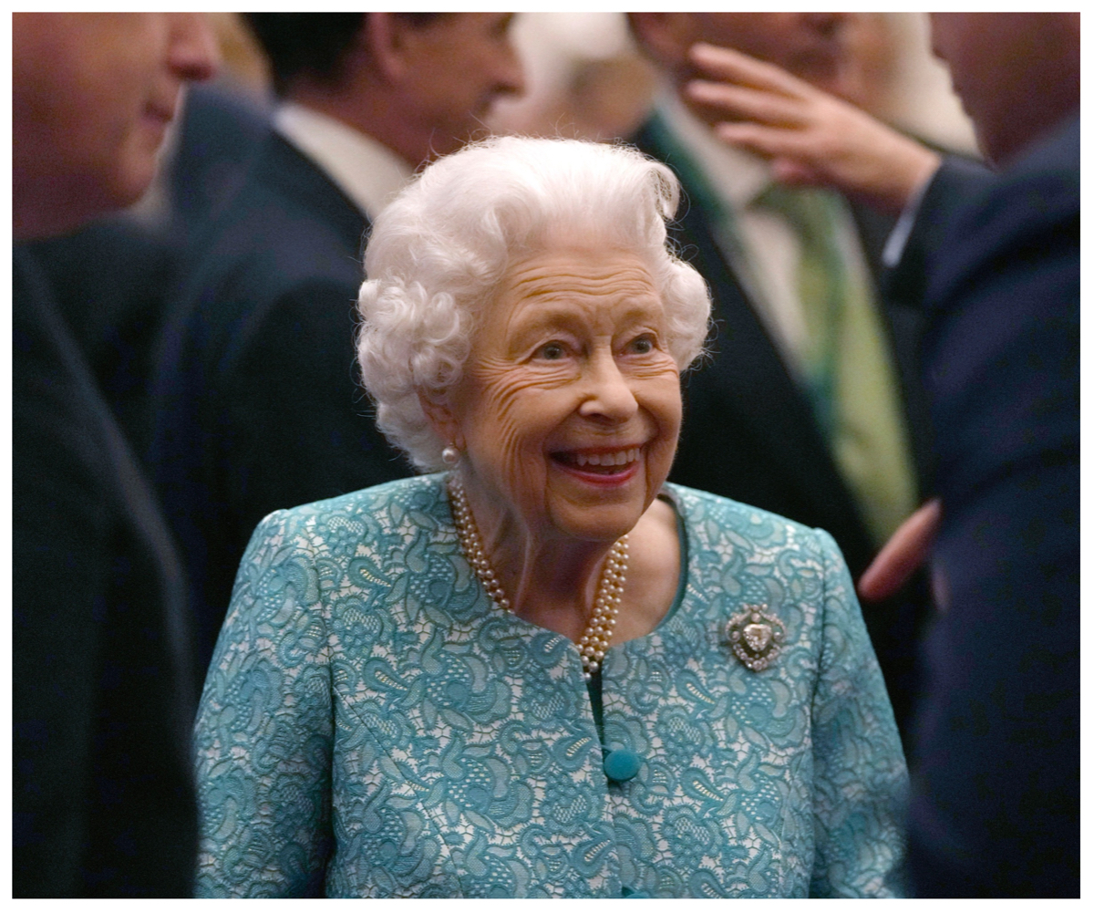 Queen Elizabeth, who has a room for her dogs at the palace, smiles during an event.